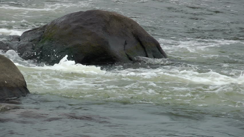 HD closeup of boulder in turbulent fresh water;1920x1080