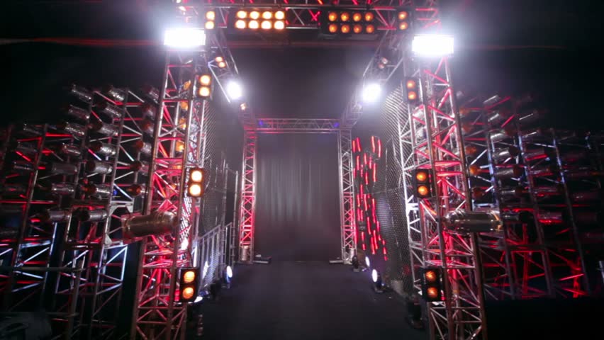 Gate of metal constructions with colorful illumination, light rays and flashes