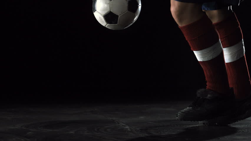 Close-up foot kicking soccer ball