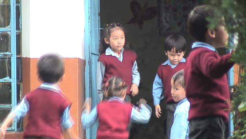 MCLEOD GANJ, INDIA - AUGUST 20, 2006: Kids Playing outside an Indian-Tibetan School on August 20, 2006. The Government of India built special schools for Tibetans that provide free education, health care and scholarships for those students who excel in sc