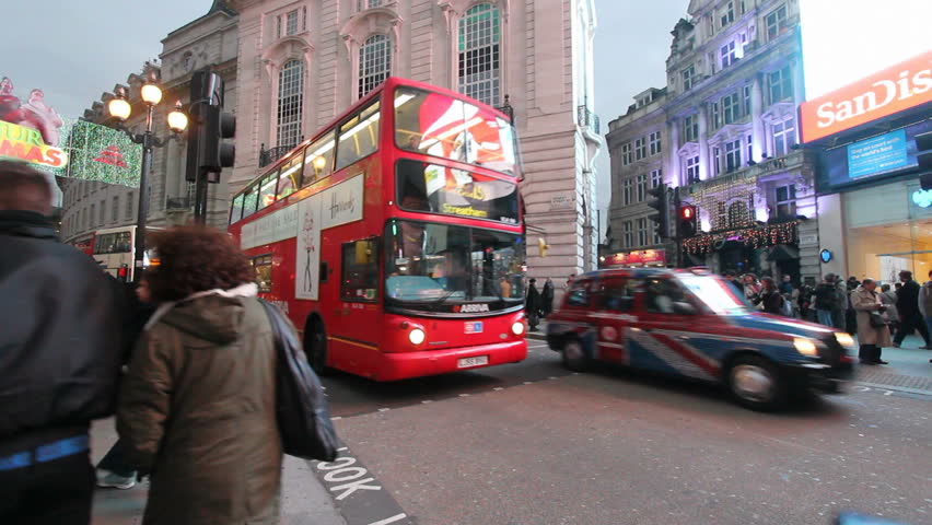 LONDON, UK - DECEMBER 27: Tourists, busses and other traffic on Piccadilly Circus drive by on December 27, 2011 in London, UK. Piccadilly Circus is one of the main entertainment areas of London.