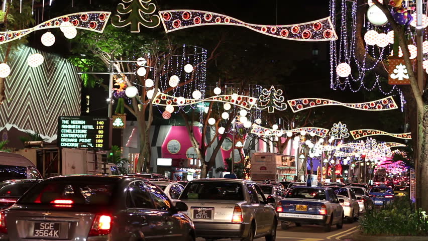 SINGAPORE - NOVEMBER 16: Orchard Road at night. Private and public vehicles pass below the famous lavish Christmas decoration on November 16, 2009 in Singapore.