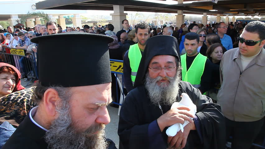 QASR AL YAHUD, ISRAEL - JANUARY 18: Greek Orthodox    Priest holds the white pigeon during the Epiphany at Qasr Al Yahud, Israel on January 18, 2012.