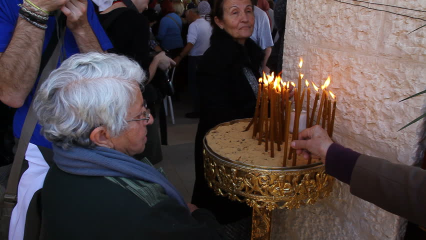 QASR AL YAHUD, ISRAEL - JANUARY 18: Pilgrim light candles during the Epiphany at Qasr Al Yahud, Israel on January 18, 2012.