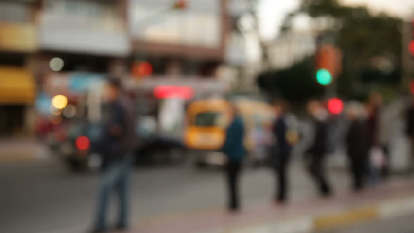 Unrecognizable blurred people waiting on busy street.