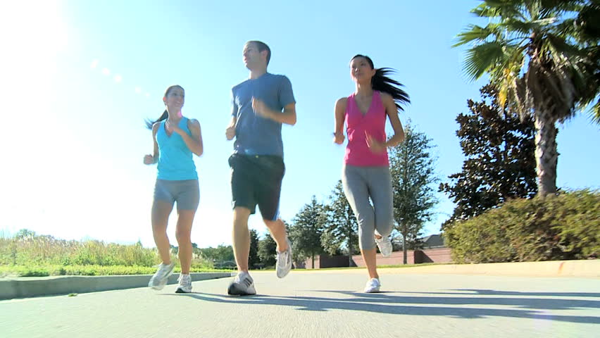 Young multi ethnic friends keeping to a fitness program together jogging outdoors