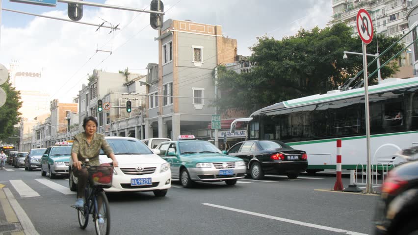 GUANGZHOU - NOV 23: (Timelapse View) People and cars go on road through pedestrian crossing in Haizhu District, on Nov 23, 2011 in Guangzhou, Guangdong, China