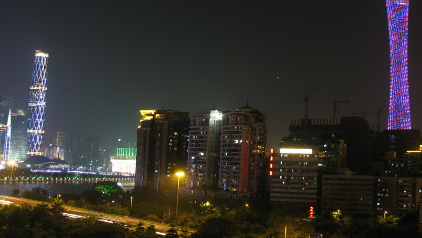 Twin Tower and TV Tower stands on against city landscape in night, time lapse