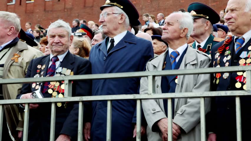 MOSCOW - MAY 9: Many veterans stand on Red square near Kremlin wall and Spasskaya tower at Victory Parade on May 9, 2011 in Moscow, Russia