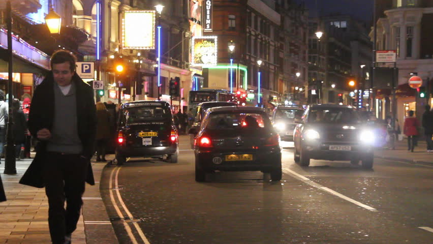 LONDON, UK - DECEMBER 28: Tourists, busses and other traffic on Shaftesbury Avenue drive by on December 28, 2011 in London, UK. Shaftesbury Avenue is the location of many theaters in London.