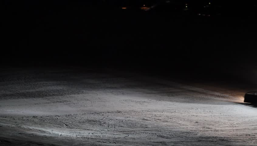Snow-plow preparing a ski slope for skiers during the night