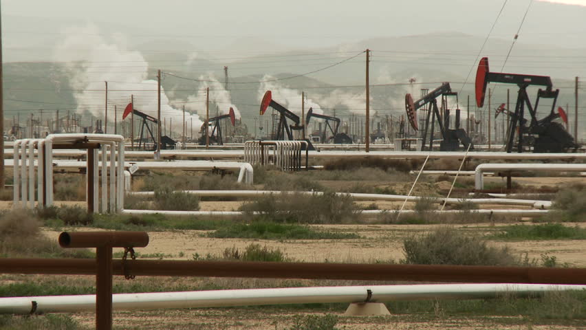 A field of pumpjacks pumping crude oil.