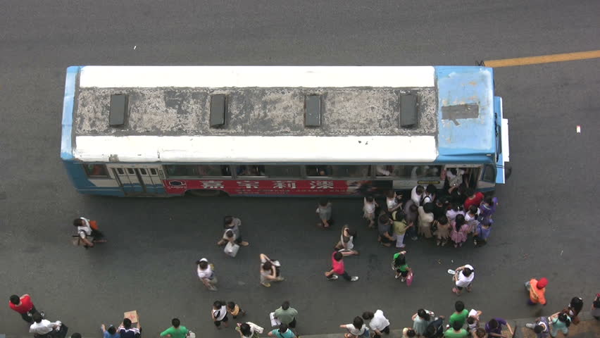 QINGDAO, CHINA - MAY 12: People board the bus on May 12, 2010 in Qingdao, China. At the present, the traffic mileage in Qingdao is more than 6.02 billion km per year.