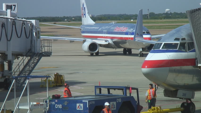 Airport workers ready to add one more bag of luggage before departure