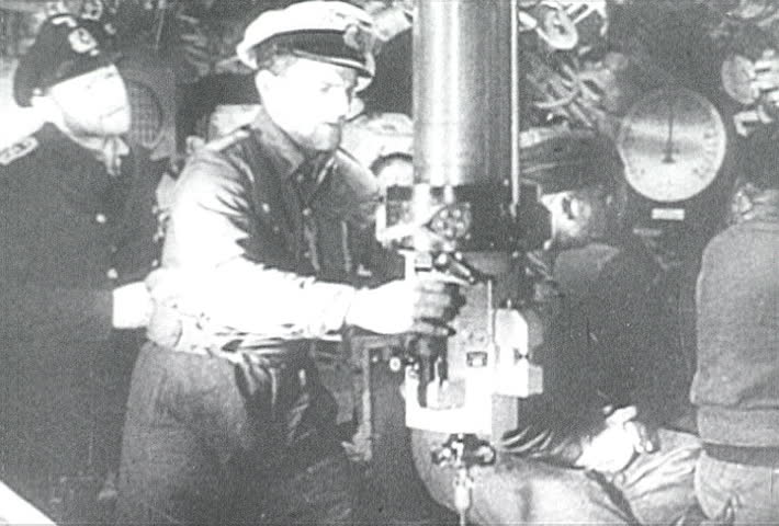 ATLANTIC OCEAN - CIRCA 1942-1944: World War II, German U-Boat Captain Looking Through Periscope, publisher National Broadcasting Service (U.S.)