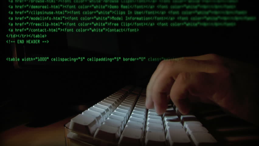 Typing code on a computer.