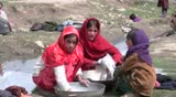NECHEM, AFGHANSTAN - JUNE 2: Young girls washing clothes on June 2, 2010 in Nechem, Afghanistan. These girls combine domestic work with attending school.