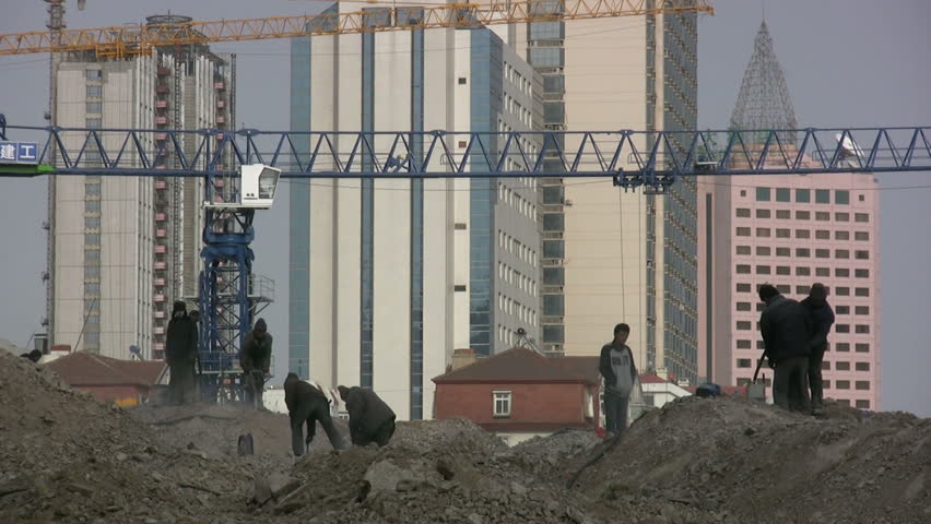 QINGDAO - MARCH 19: Workers are busy at a construction site on March 19, 2010 in Qingdao, China.