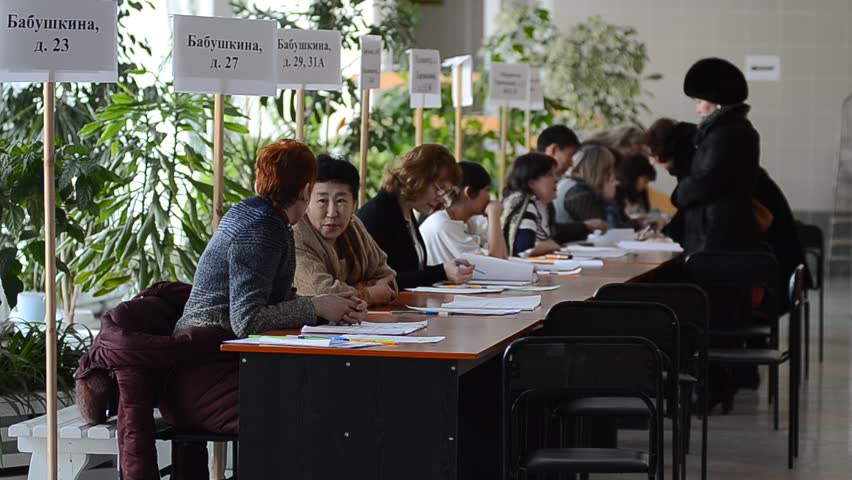 ULAN-UDE, RUSSIA - MARCH 4: The divisional election committee 699 of Burytia Republic register voters at the presidential election of Russian Federation on March 4, 2012 at a local polling station in Ulan-Ude, Buryatia, Russia.