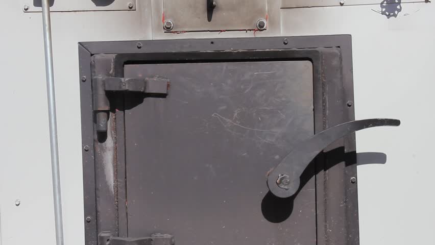 Two hands working to open furnace door