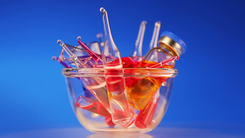 Health care / medical concept: many vivid ampoule rotating on blue background, 2 views, loop ready