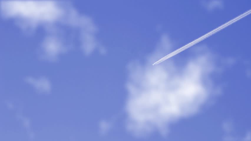 jet airplane on blue sky with condensation trail