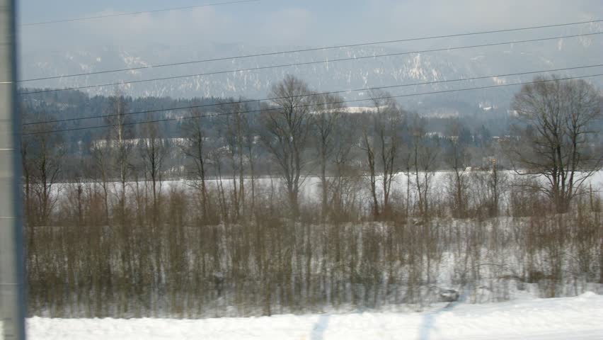 Train goes by rail near with inhabited locality along electric mains, time lapse