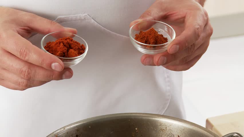 Goulash meat being dusted with paprika and stirred