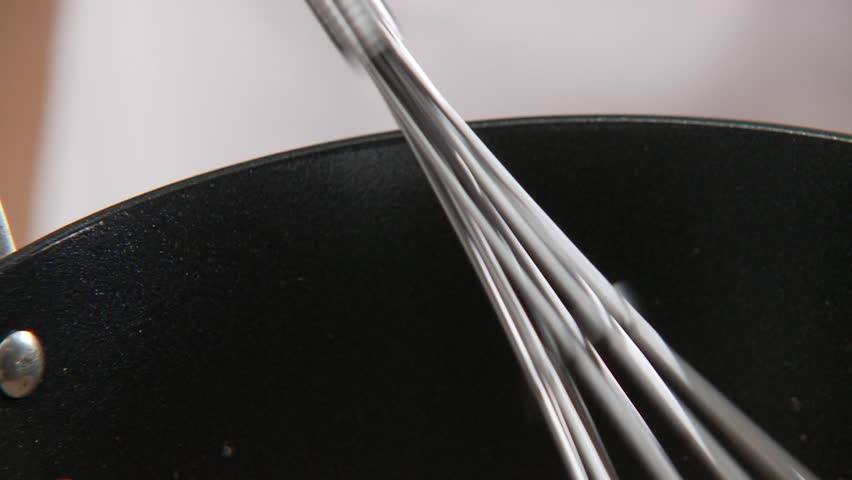 Cream being stirred into gravy