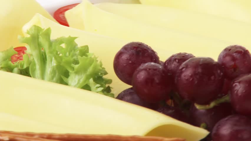 Cheese platter with grapes and salted sticks