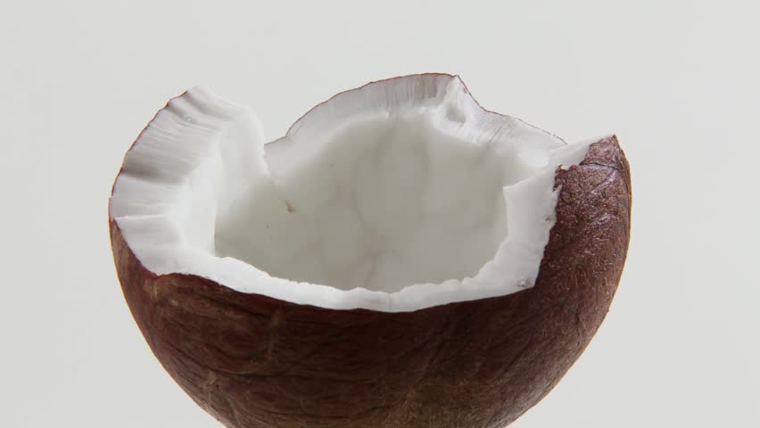 Filling half a coconut with chocolate sauce