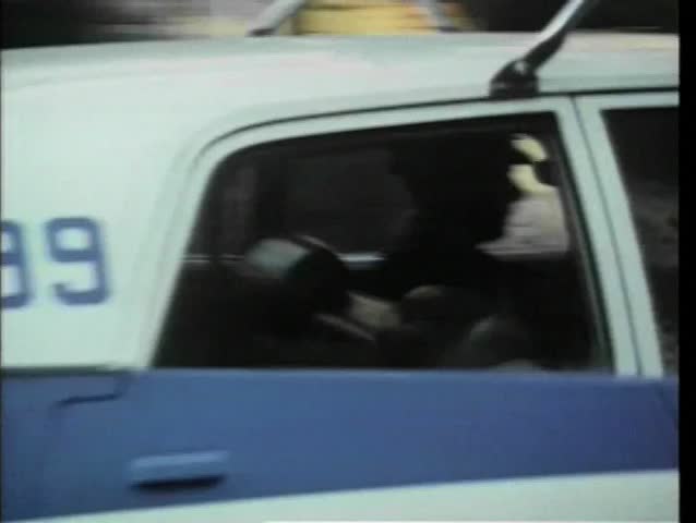 1970s police car driving through New York City streets