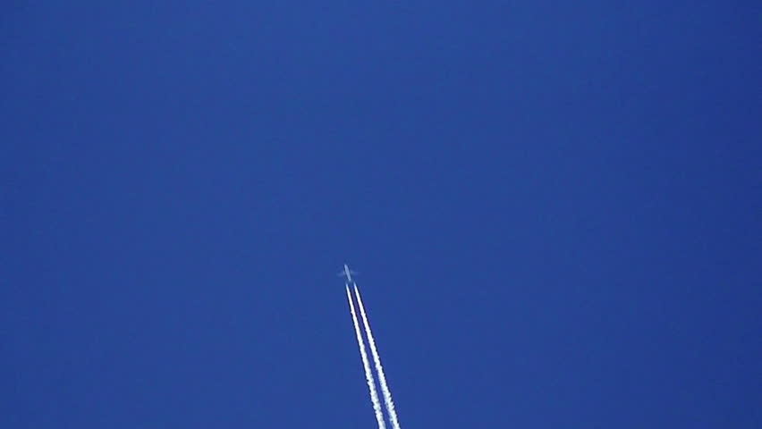 Airplane vapour trails across clear blue sky 6