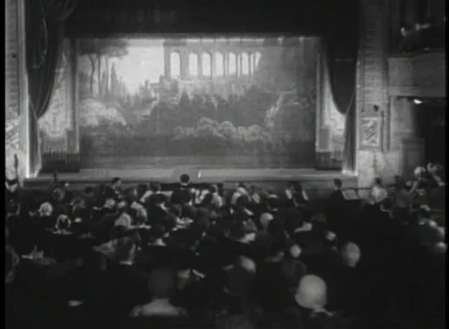 Wide shot of clown on stage beginning performance