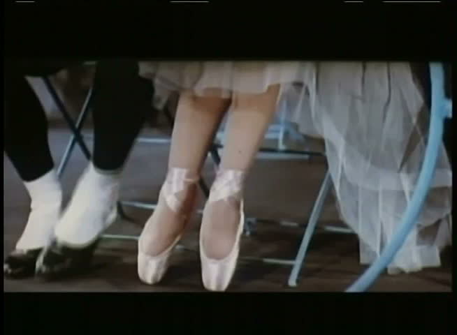 Close-up of male and female feet flirting