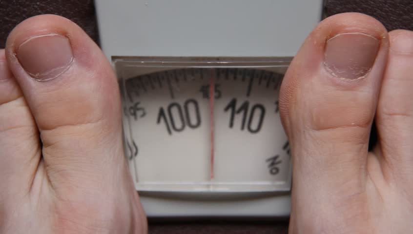 Checking one's weight on a scale
