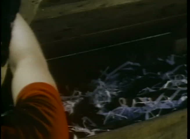Over-the-shoulder shot of person finding gun in crate