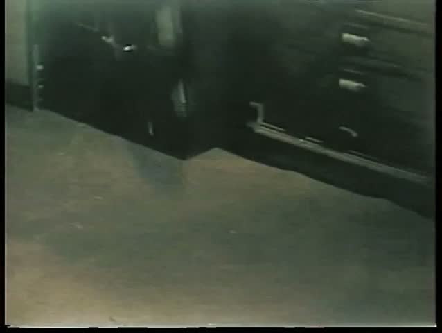 Rotary phone thrown on floor and landing near file cabinet