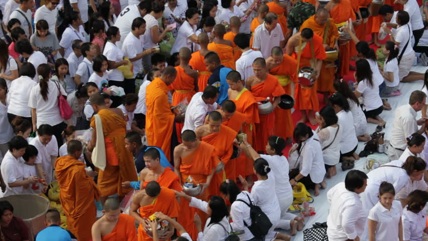 BANGKOK - MARCH 18: Monks are participating in a Mass Alms Giving of 12,600 monks in Central World for the Makha Bucha celebrations on March 18, 2012 in Bangkok, Thailand