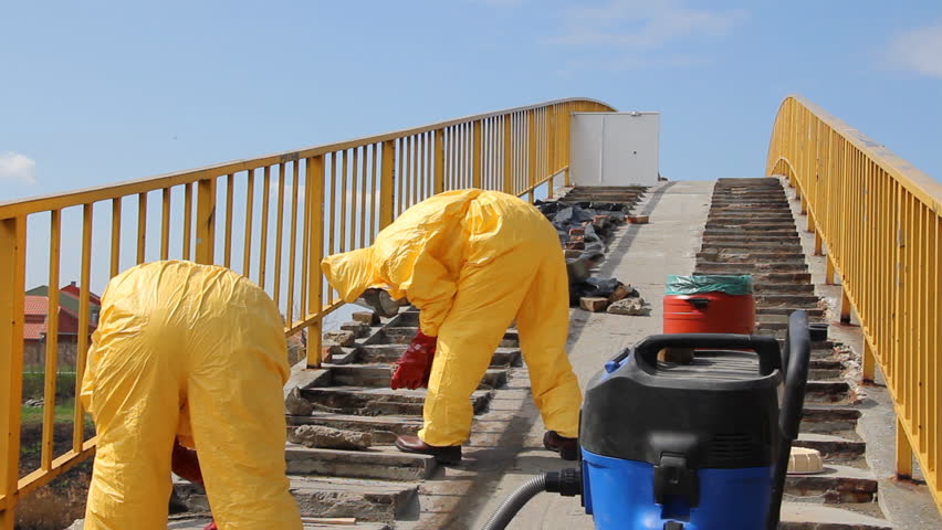 Professional  people in protective uniform removing of chemicals and dangerous materials