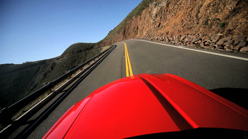 Luxury car road trip on winding Pacific highway