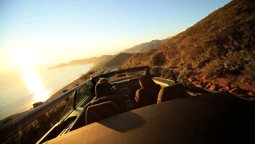 Luxury car road trip on winding Pacific highway