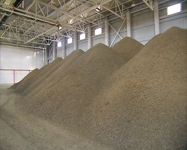 rape seed oilcake remaining after oil and biodiesel production from rape collapsing in pile. feed for animals used in agriculture industry.