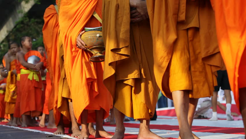 BANGKOK - MARCH 25: Monks are participating in a Mass Alms Giving of 12,600 monks in Central World for the Makha Bucha celebrations on March 25, 2012 in Bangkok, Thailand.