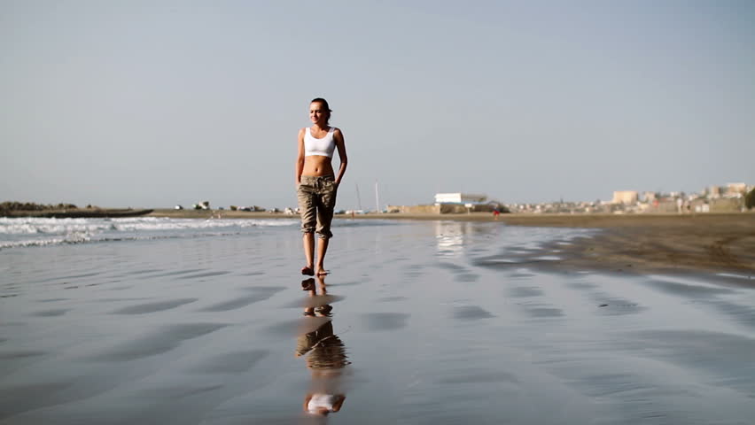 Young woman walking on the beach
