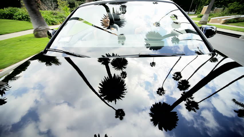 Young Caucasian girls laughing luxury cabriolet