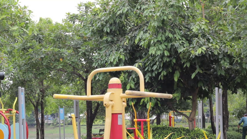 A young man begins exercising at a local park.