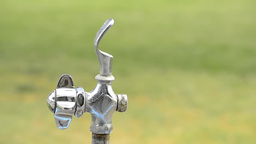 Drinking fountain in park with flowing water