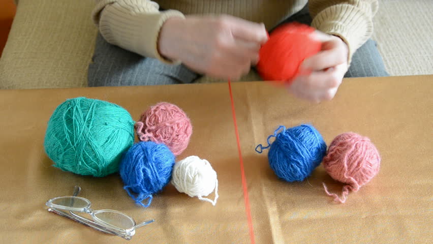 Grandmother hands winding yarn on a ball 
