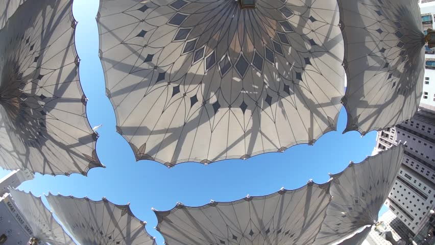 Fisheye view of giant umbrellas at Masjid Nabawi (Mosque) compound in Medina, Kingdom of Saudi Arabia. Nabawi mosque is the second holiest mosque in Islam. 
